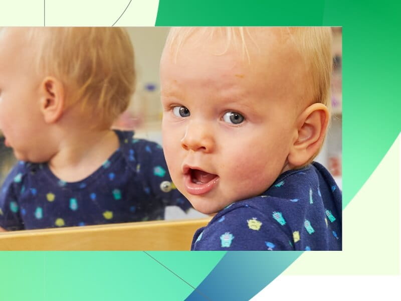 baby looking in mirror