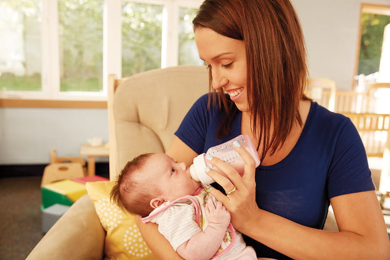 Woman feeding infant child