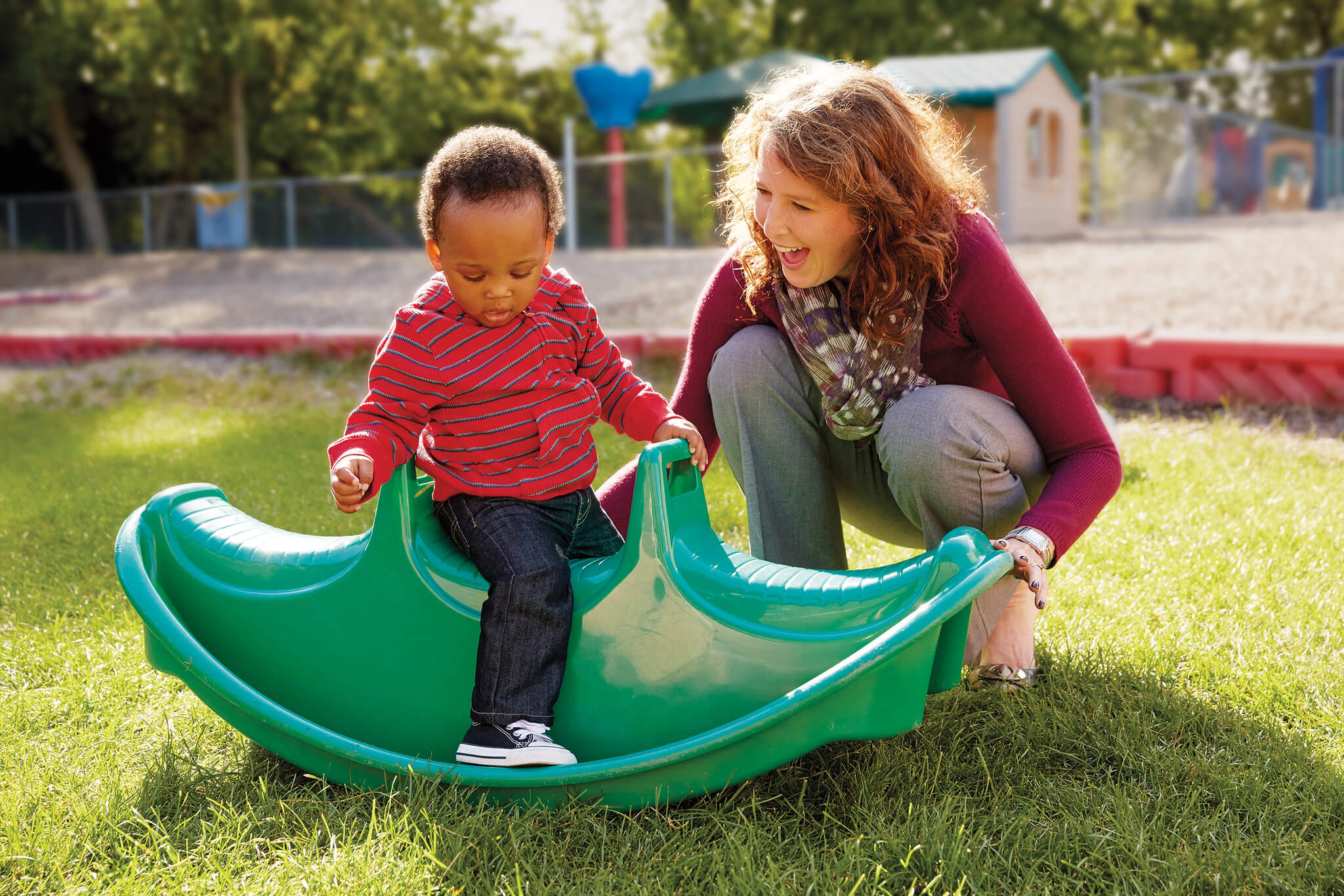 kid and teacher playing on playground