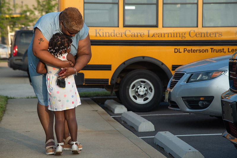 Mom hugging child at daycare drop-off