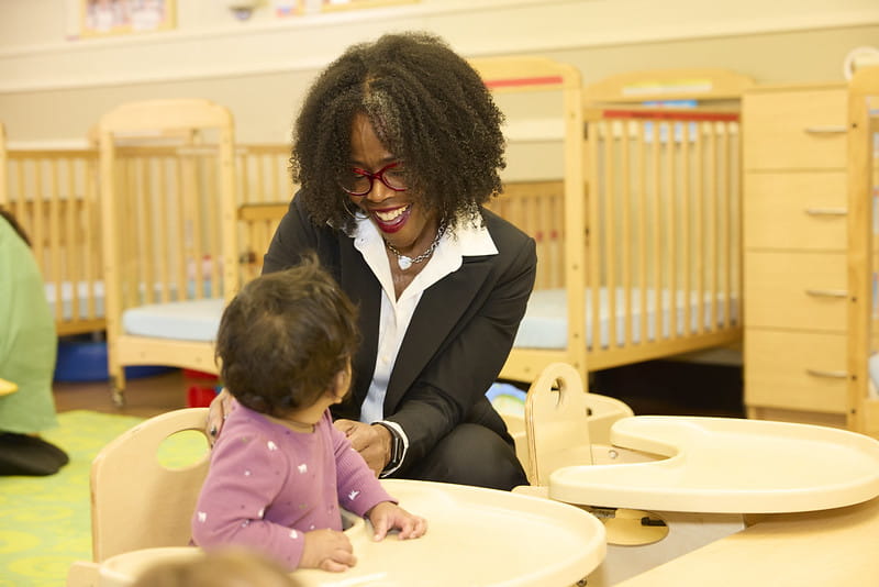 Woman sitting at table with child