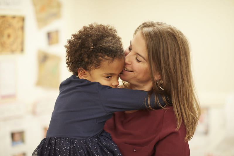 Woman holding and hugging child