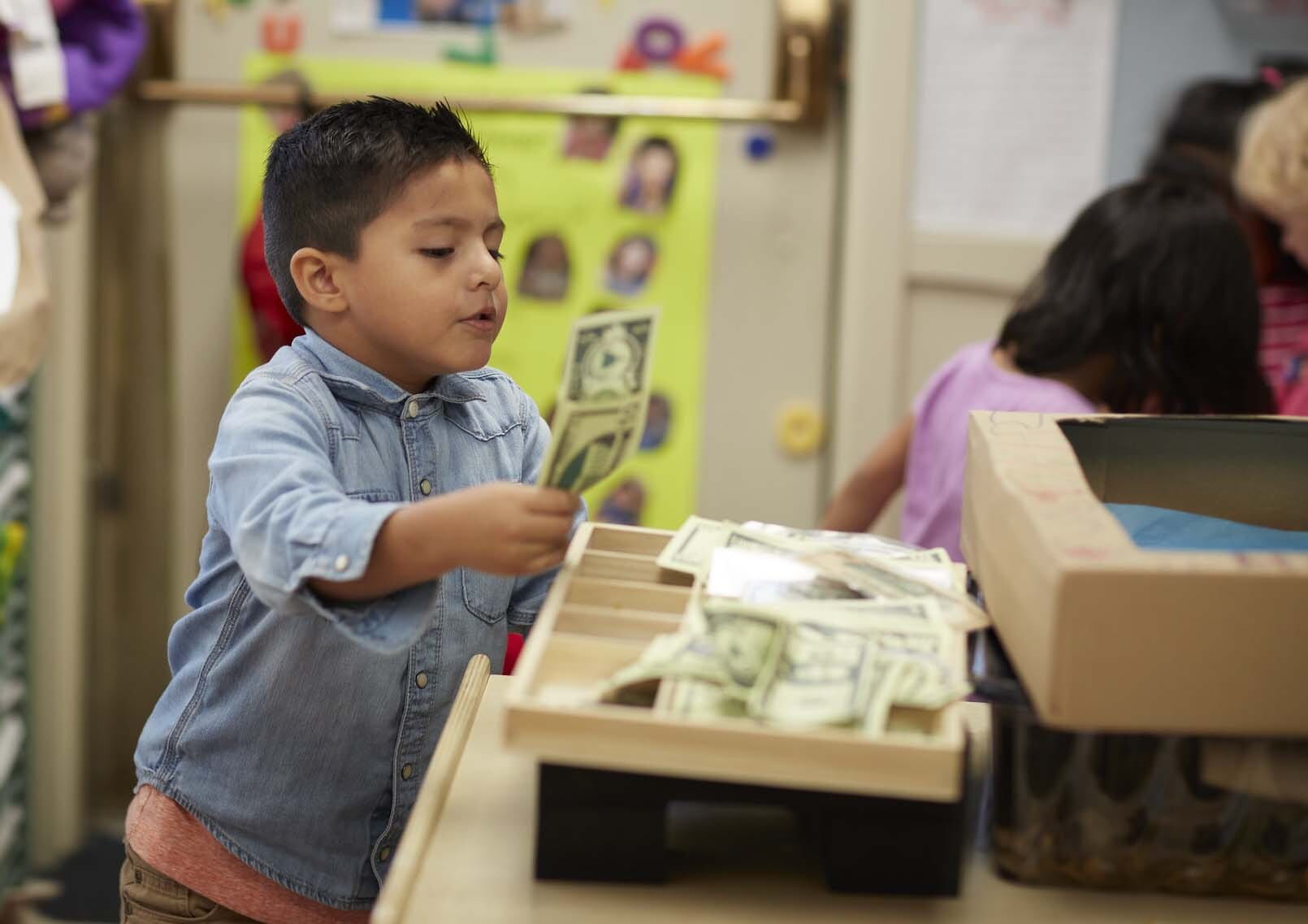 Child playing with cash register