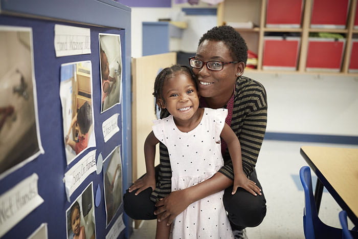 Parent and child smiling in center