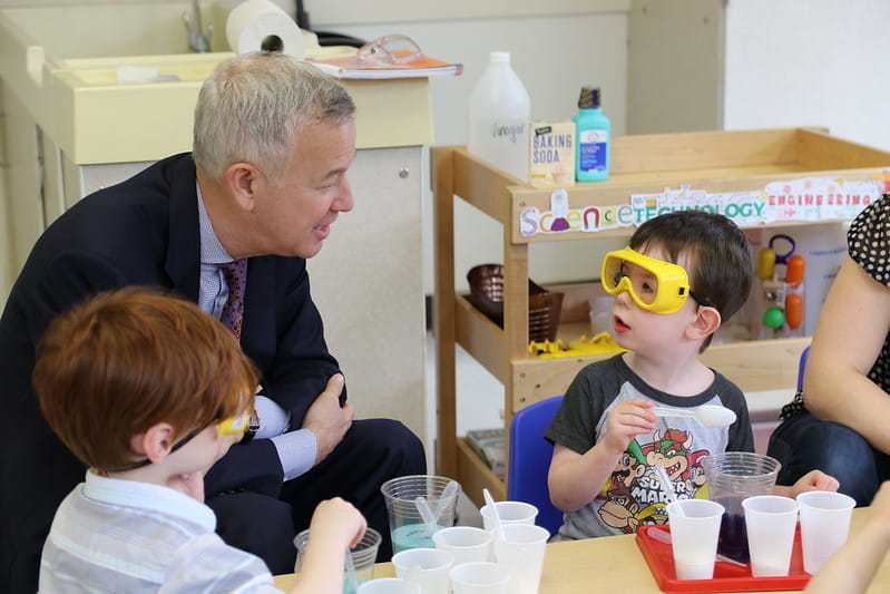 Chairman and CEO, Tom Wyatt, pictured with children at a KinderCare center.