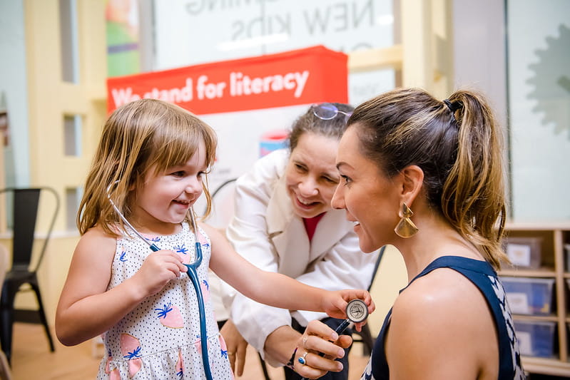 Child role playing as doctor