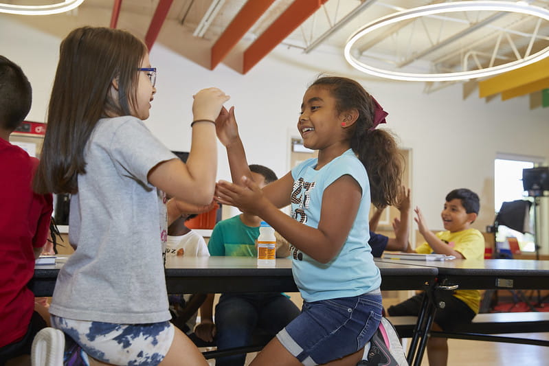 Two children playing a hand clapping game