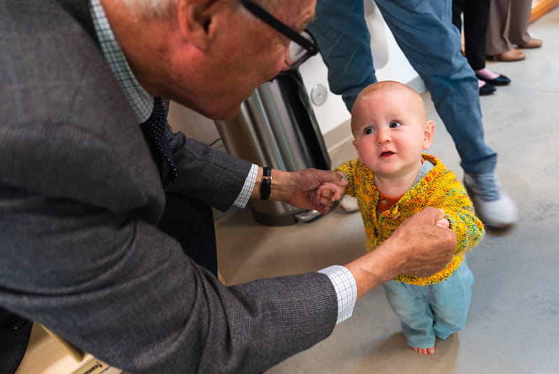 Adult holding babies hands