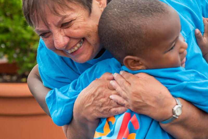 teacher hugging kid